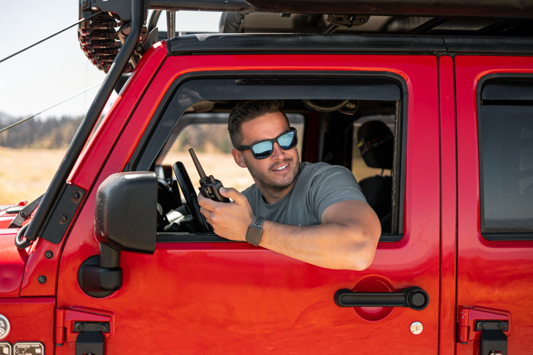 Josh leaning out of Clifford's window with a radio